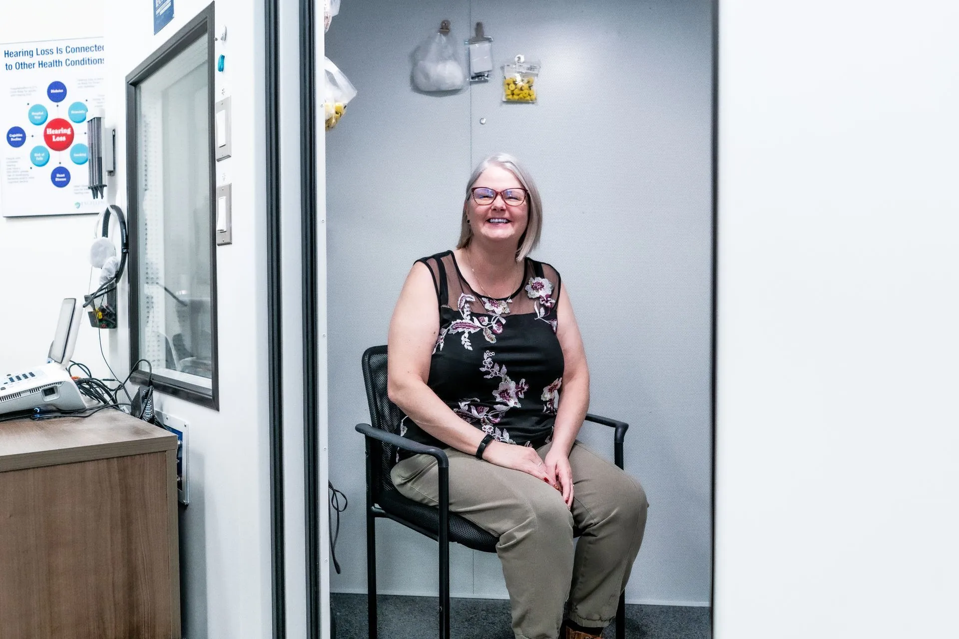 A patient seated in a Calgary Ear Centre exam room